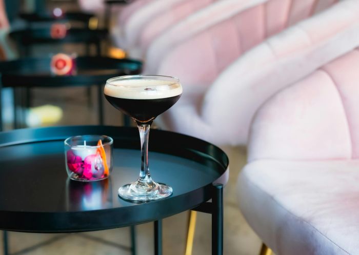 Espresso martini on a little side table next to a row of armchairs at Millsheds Bar and Distillery, Bowral - Credit: Merrigangs Distillery and Bar