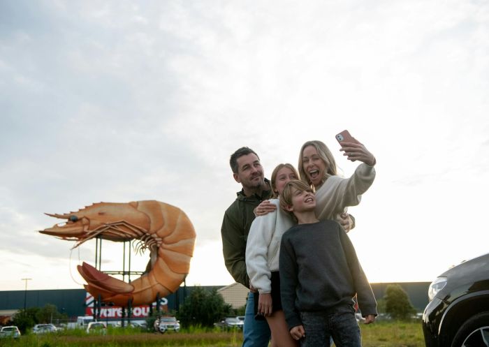 Image with family taking a selfie with statue, Big Prawn, Ballina