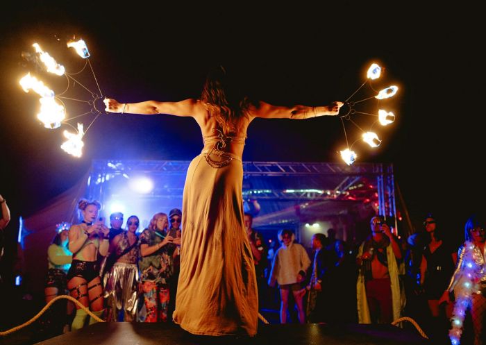 Female fire dancer on stage with audience looking up at her at the Secret Valley Festival, Glen Davis - Credit: Secret Valley Festival PTY LTD