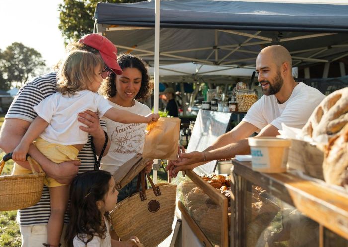 Family buying products from a bakers stall, Ballina Farmers and Producers Market, Ballina  - Credit: Ballina Farmers and Producers Market