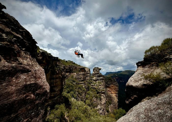 A para adventurer hanging on a magnificent tyrolean traverse, Blue Mountains Climbing School, Blackheath - Credit: Blue Mountains Climbing School