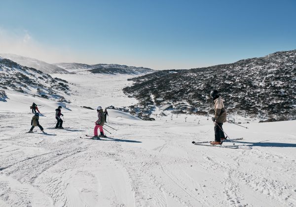 Family enjoying a day of skiing at Charlotte Pass Ski Resort in the Snowy Mountains