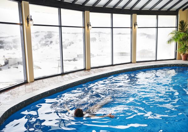 Woman enjoying a swim at Perisher's only heated pool in the Marritz Hotel, Perisher, Snowy Mountains