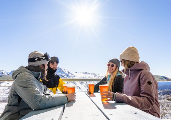 Friends enjoying drinks in Perisher, Kosciuszko National Park - Snowy Mountains
