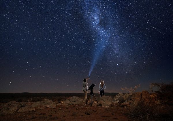 Couple star gazing beneath the Milky Way, Outback Astronomy, Broken Hill
