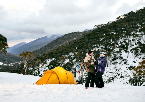 Couple relaxing by their tent in Dead Horse Gap, Thredbo, Snowy Mountains