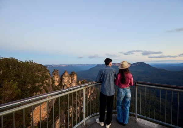 Couple looking at view of Three Sisters, Echo Point, Katoomba