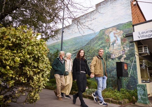 Family walking down street with murial, Leura