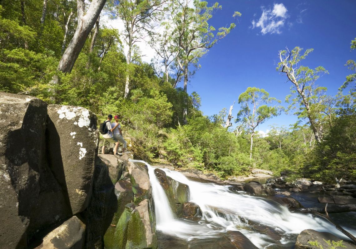 Couple admiring Gloucester Falls at Gloucester Tops, Barrington Tops National Park, NSW, Australia