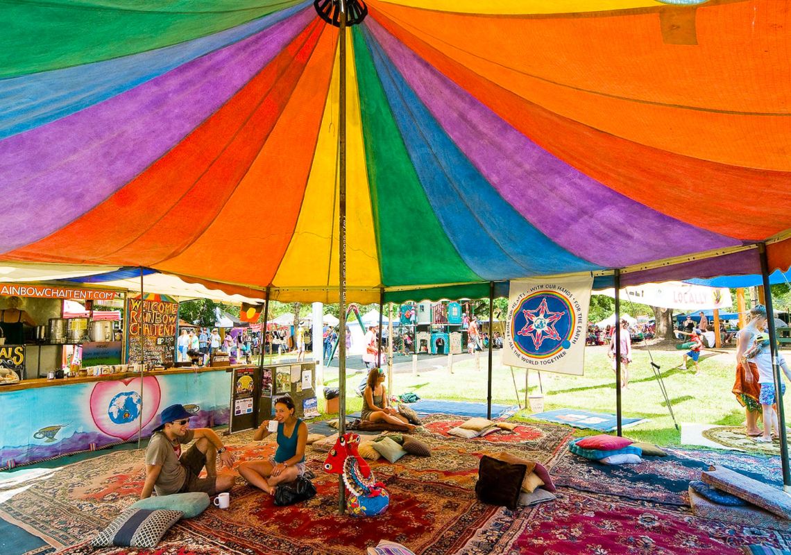 People relax under a colourful tent at Channon Craft Market, near Lismore