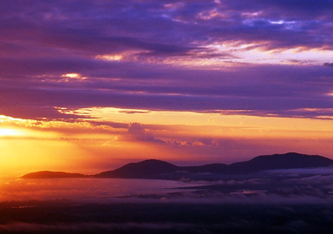 A sunrise peeks through clouds, Yarriabini lookout, NSW, Australia