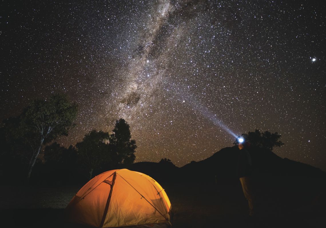 Camper gazing up at the galaxy of stars, Warrumbungles