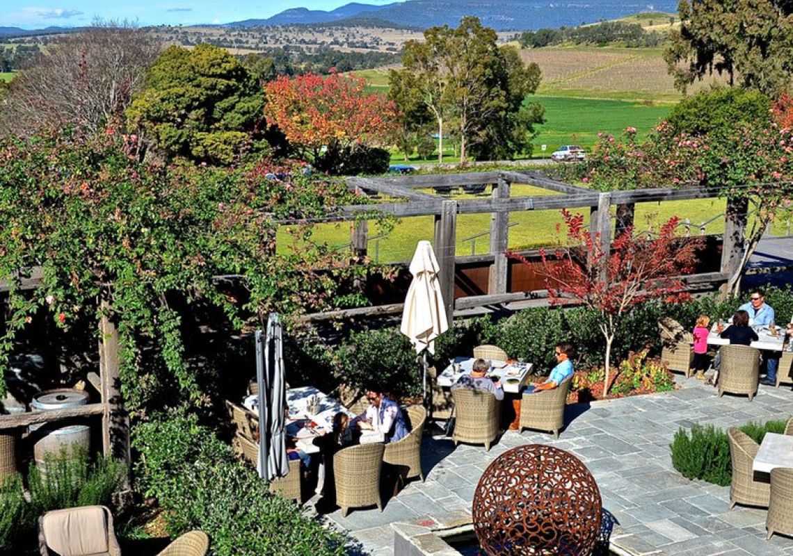Diners enjoying outdoor dining with scenic vineyard views at Vines Restaurant in Hollydene Estate, Upper Hunter