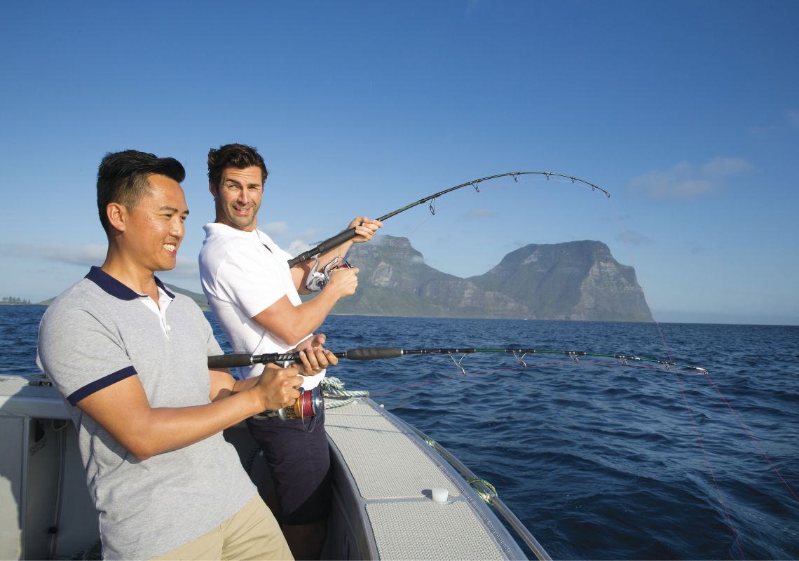 Friends enjoying a day out in the ocean deep sea fishing off Lord Howe Island