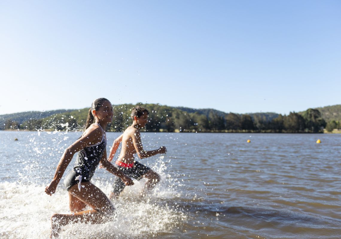 Children enjoying a day swimming in the Hawkesbury River by Leetsvale Caravan Park in Leets Vale, Hawkesbury Valley