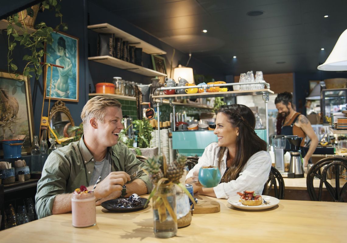 Couple enjoying food and drink at Flock Cafe, Lismore