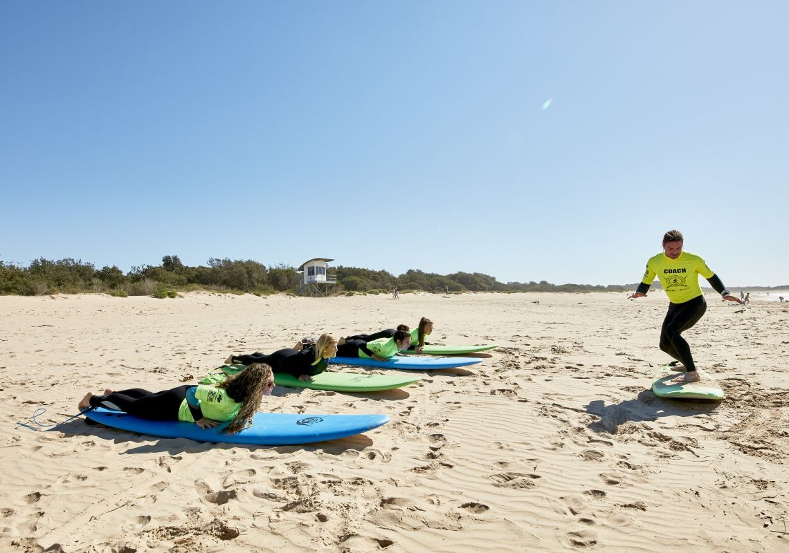 Women learning how to surf with Illawarra Surf Academy on Corrimal Beach near Wollongong 