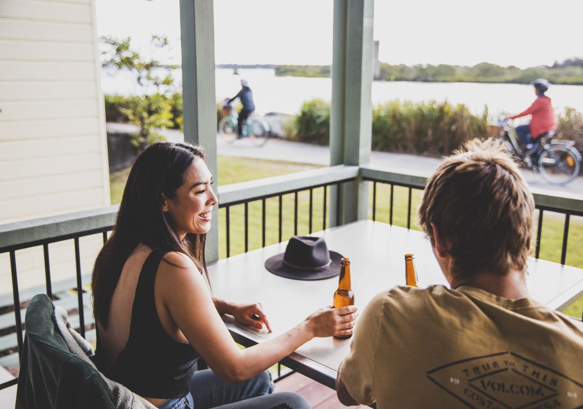 Ein Paar genießt die malerische Aussicht von seiner Villa am Wasser im Calypso Yamba Holiday Park in Yamba, Clarence Valley