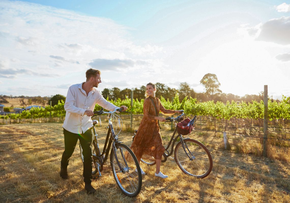 Couple enjoying a bike ride around the Clonakilla Wines vineyard in Murrumbateman, Yass Area