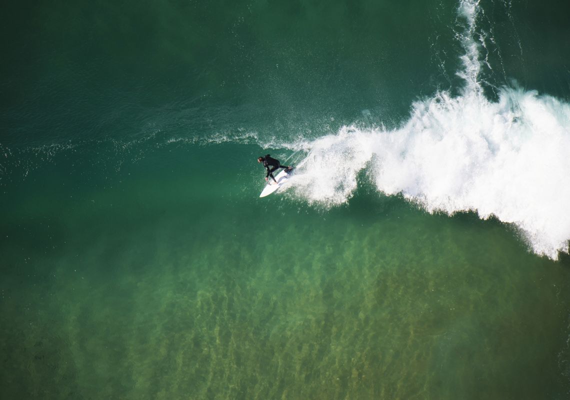 Aerial of a surfer on North Avoca beach - Central Coast