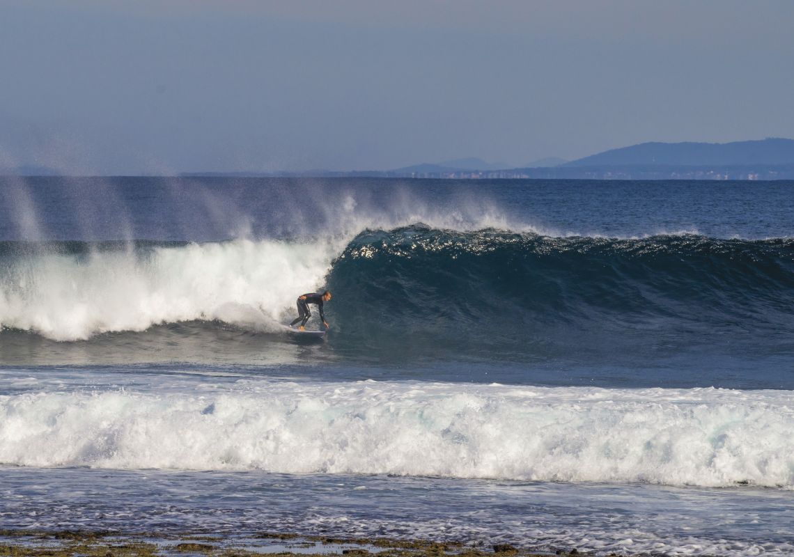 Surfing at Wreck Bay - Image Credit Dee Kramer