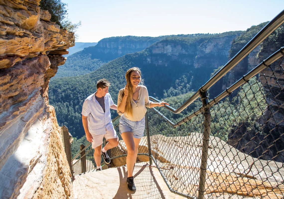 Couple enjoying a walk along the Wentworth Falls Track in the Blue Mountains National Park.