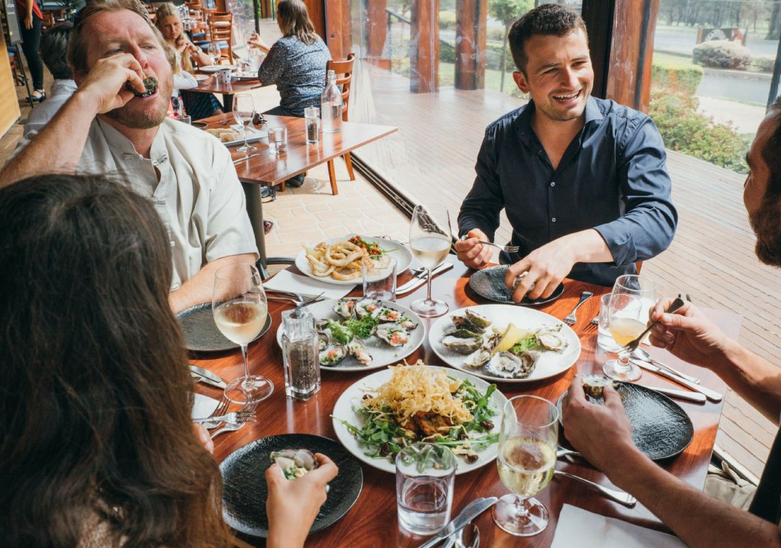 Friends sharing Seafood at Wheeler's Seafood Restaurant and Take Away in Pambula, Merimbula & Sapphire Coast, South Coast