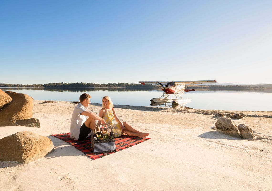 Couple having a picnic by Coila Lake in Tuross Head, Batemans Bay Area, South Coast