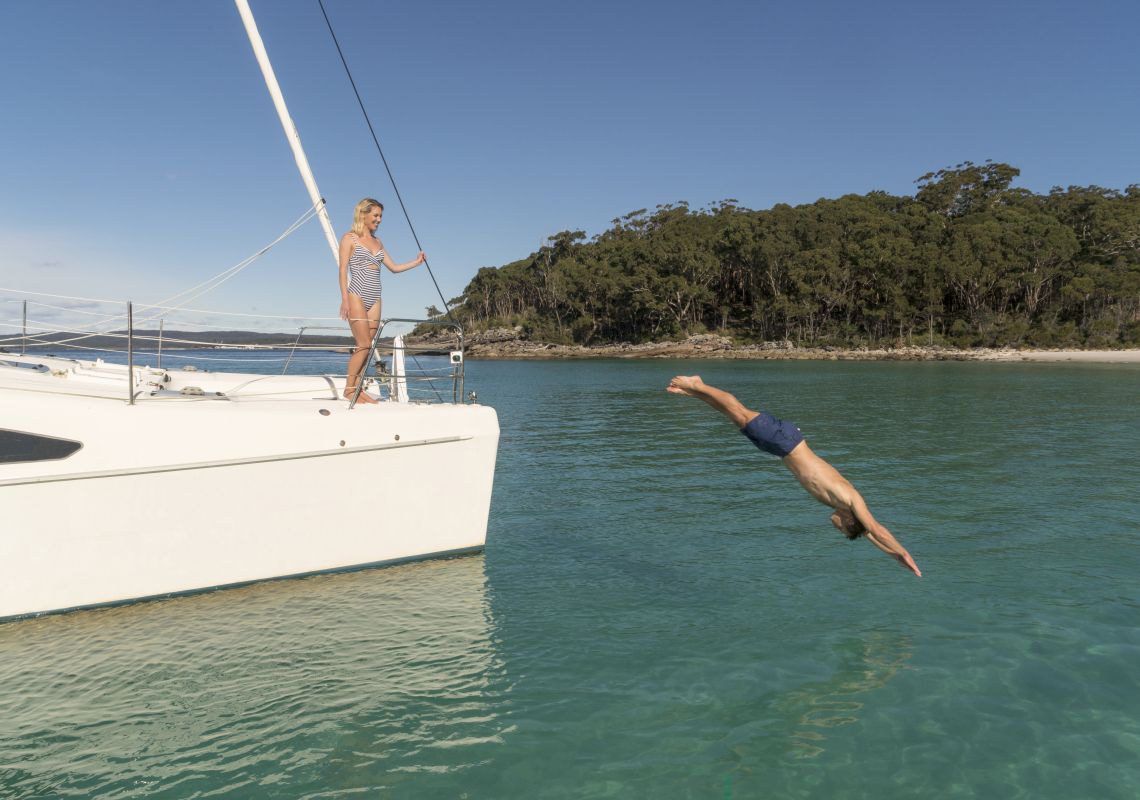 Couple enjoying a romantic day on the water with luxury sailing charter Discover Jervis Bay.
