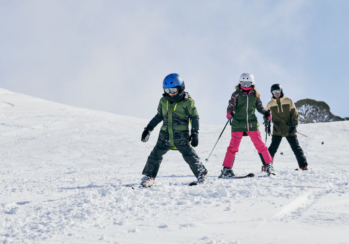 Family enjoying a day of skiing at Charlotte Pass Ski Resort in the Snowy Mountains.