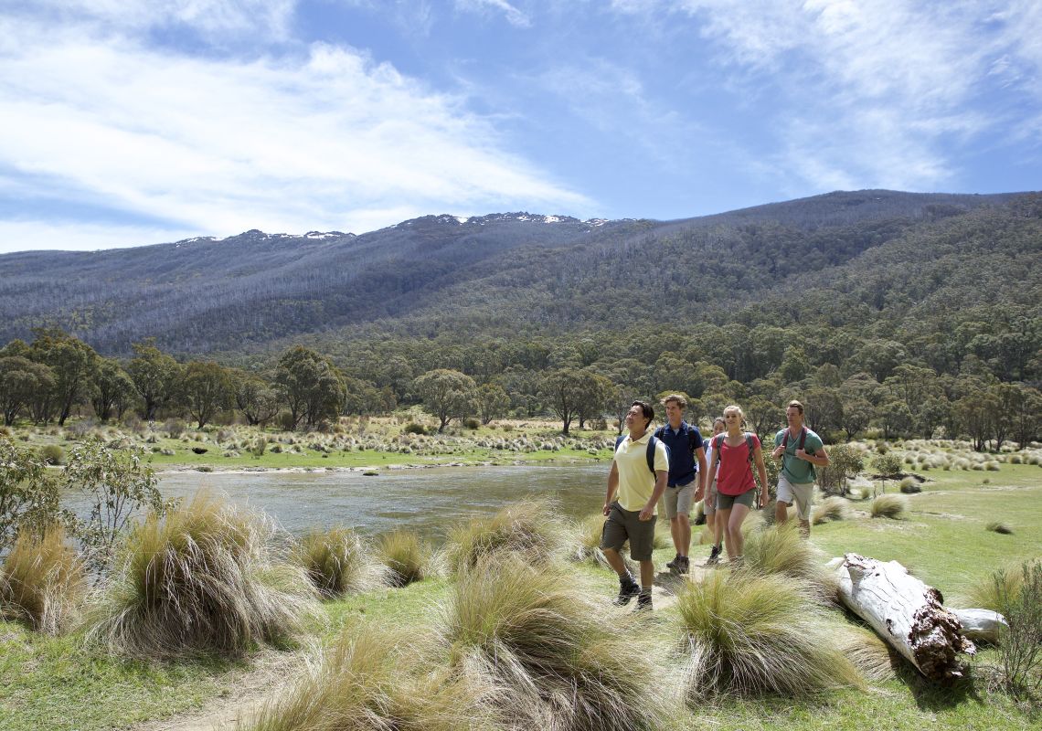 Friends enjoying a scenic bushwalk by Thredbo River near The Diggings Campground in Kosciuszko National Park, Snowy Mountains