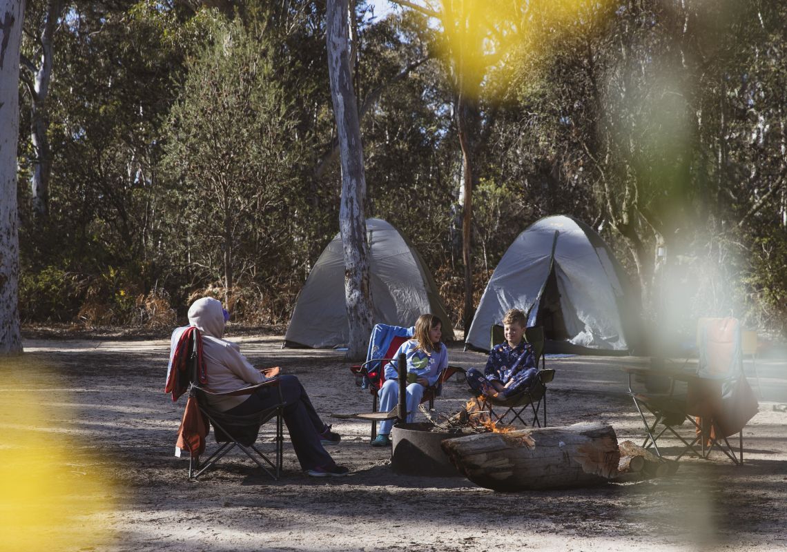 Family enjoying a morning campfire at Ganguddy-Dunns Swamp campground, Wollemi National Park