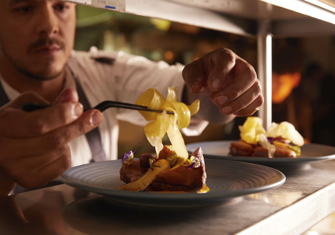 Chef Matthew Roberts placing the finishing touches to a dish at Eschalot, Berrima