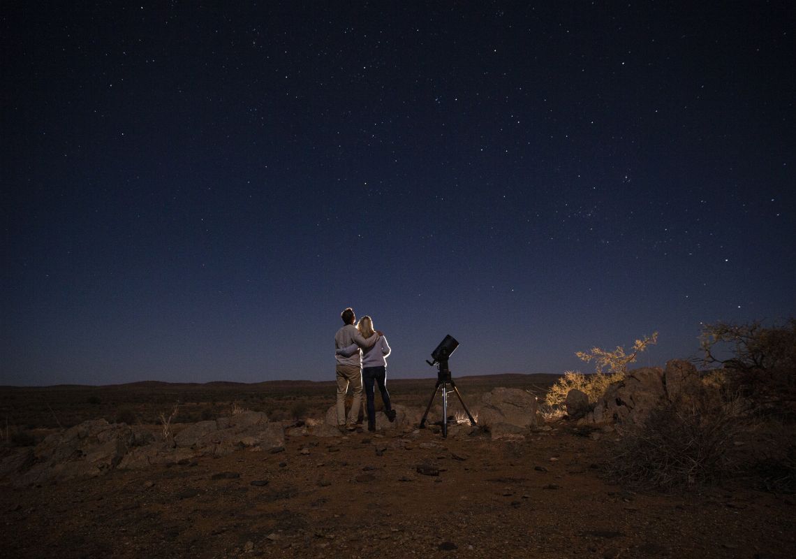 Couple star gazing beneath the Milky Way at Outback Astronomy, Broken Hill