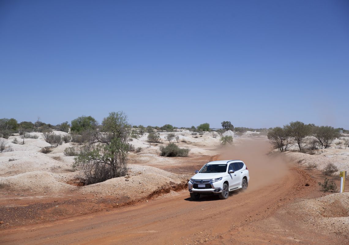 Car driving through the outback town of White Cliffs, Outback NSW