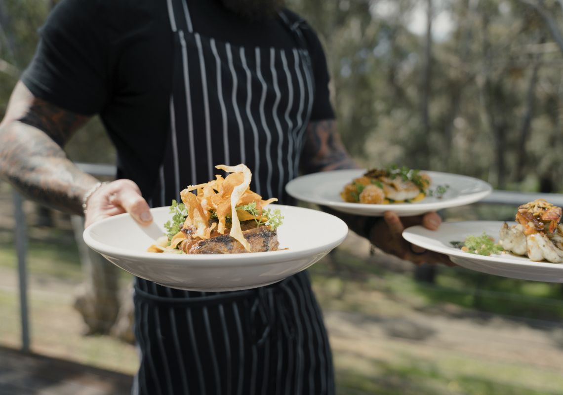 Chef serving meals at Morrisons Riverview Winery and Restaurant at Moama in Riverina, Murray