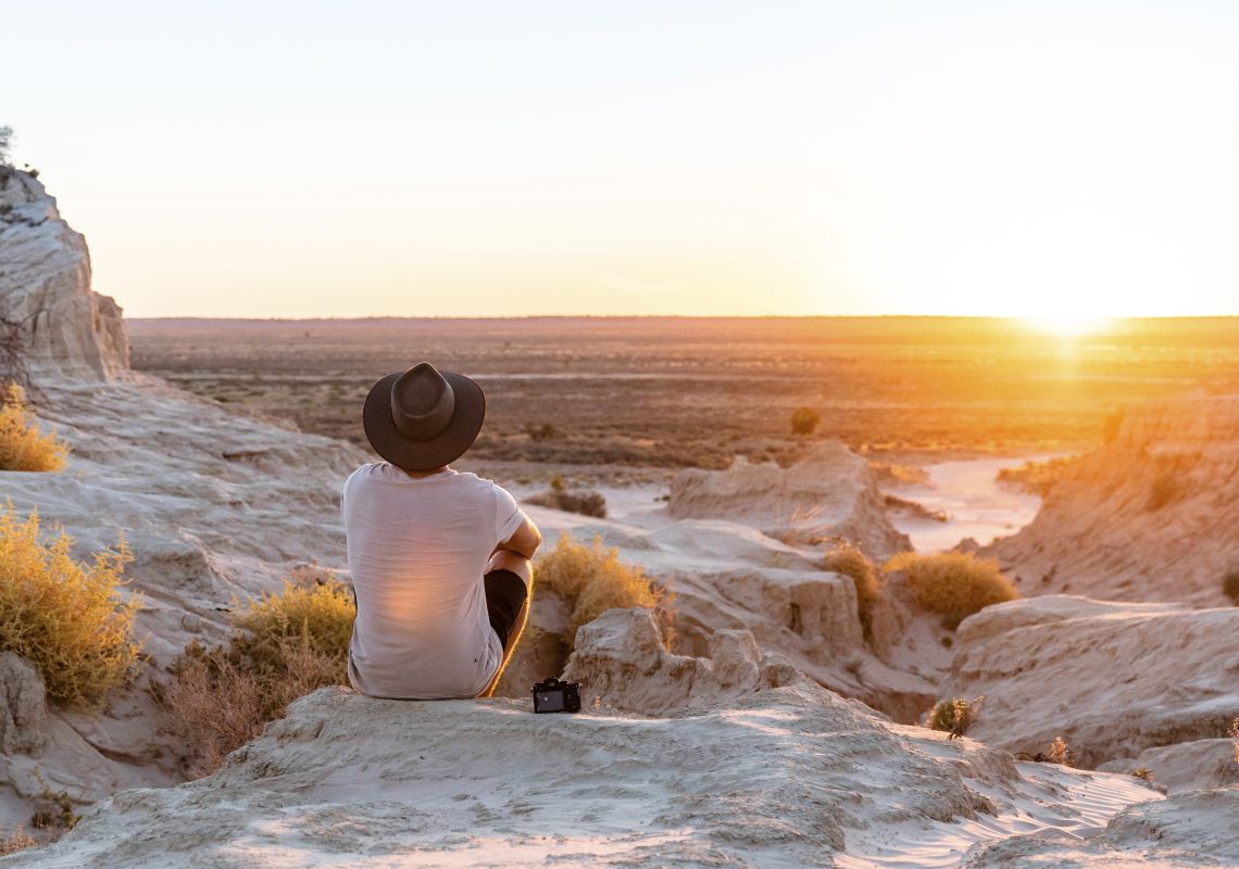 Man watching the sunset at the Walls of China in Mungo National Park, Mungo