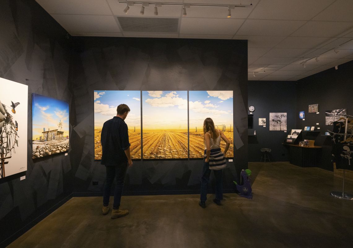 Couple viewing the artwork inside the John Murray Art Gallery, Lightning Ridge
