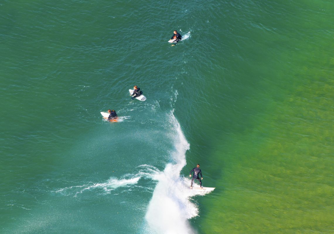 Aerial of surfers on North Avoca beach, Central Coast