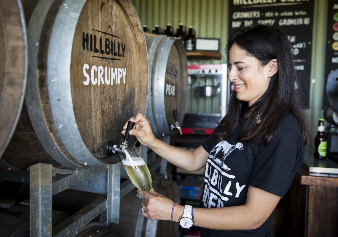 Glass of Scrumpy cloudy apple cider being poured at the Hillbilly Cider Shed, Bilpin, Blue Mountains
