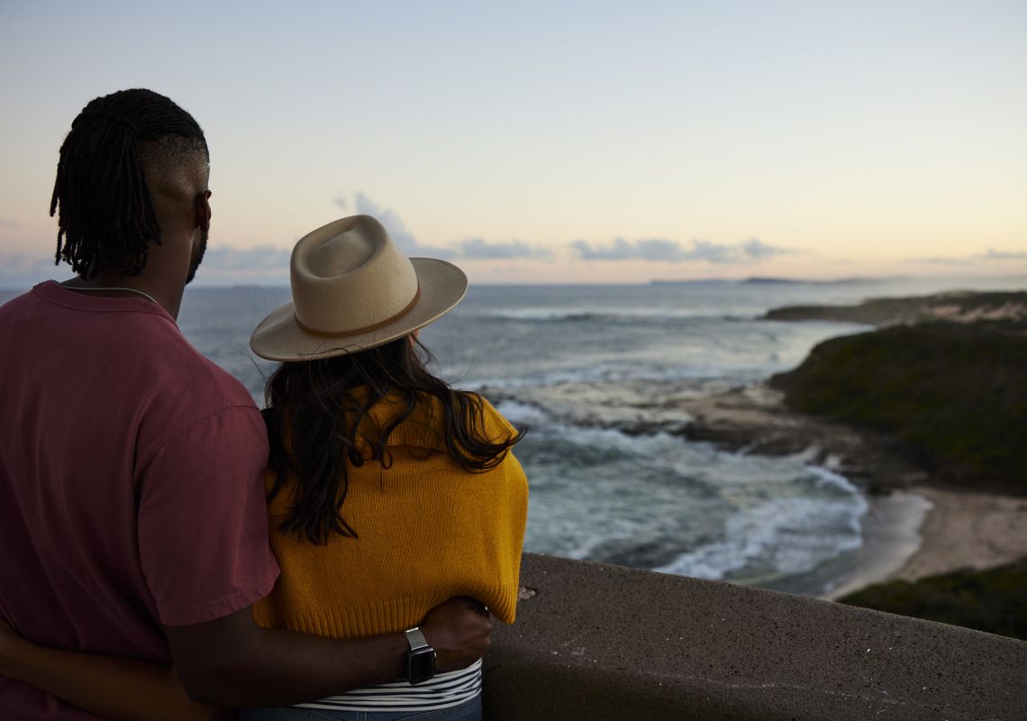 Couple enjoying the scenic coastal views from atop the Norah Head Lighthouse, Norah Head