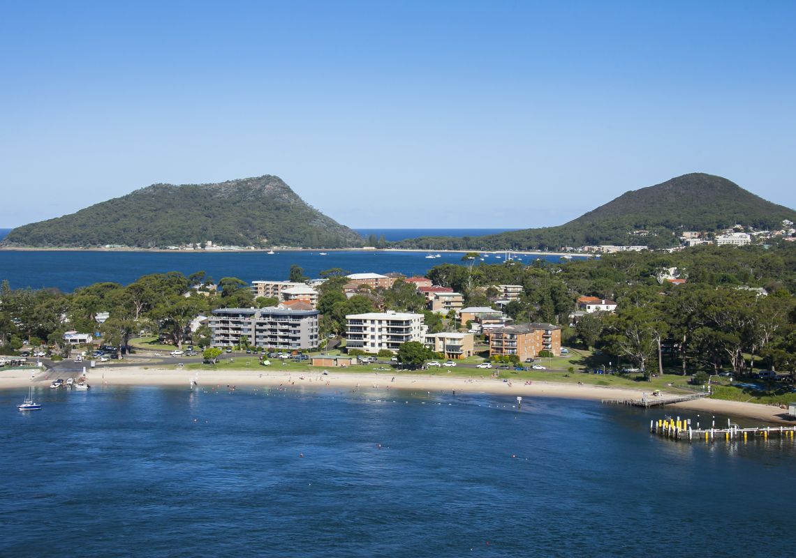 Coastal aerial of Little Beach in Nelson Bay with views to Shoal Bay and Mount Tomaree