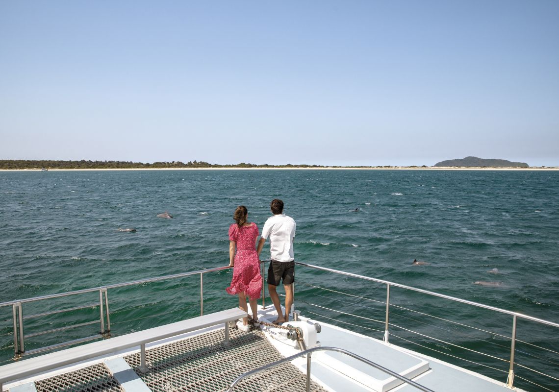 Couple enjoying a dolphin watching cruise with Moonshadow Cruises in Port Stephens