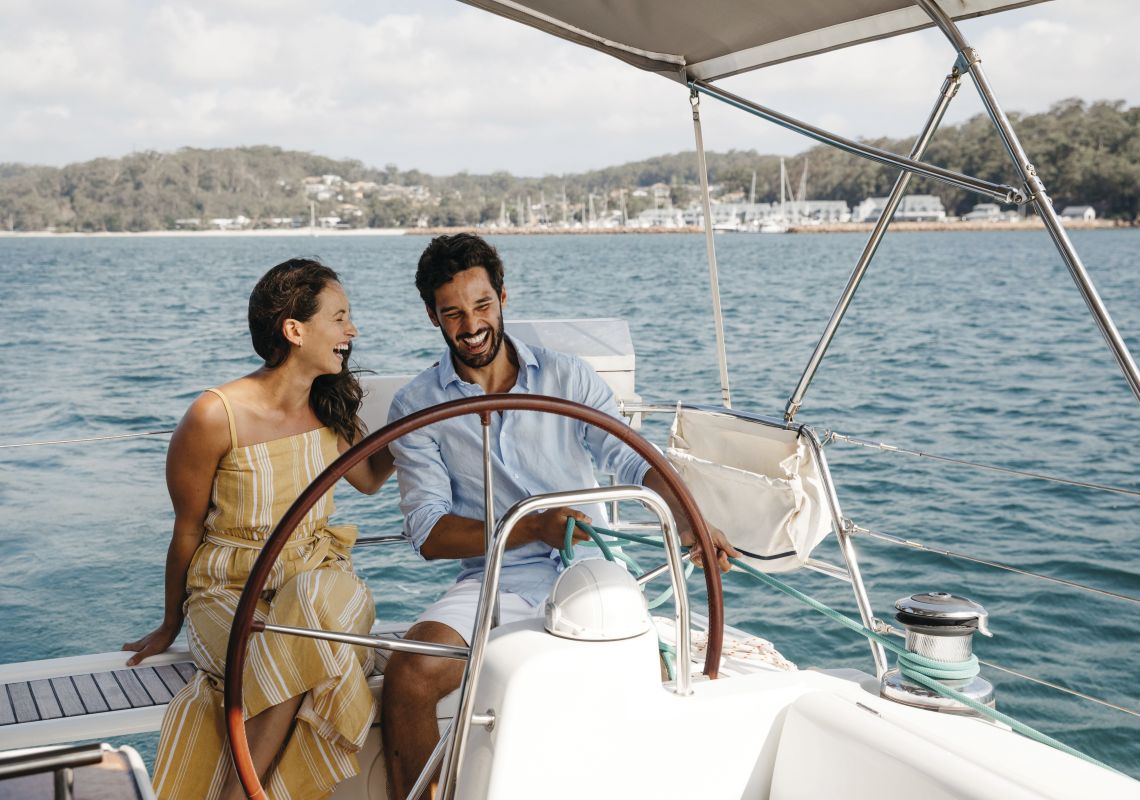 Couple enjoying a sailing experience in Shoal Bay, Port Stephens