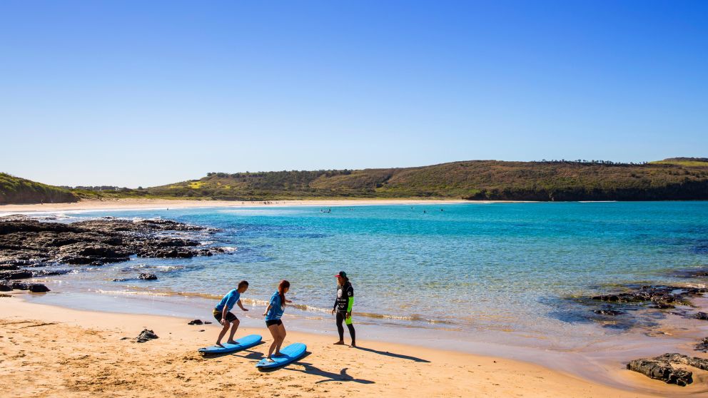 Couple taking surf lessons at The Farm in Killalea State Park, Shellharbour, South Coast NSW