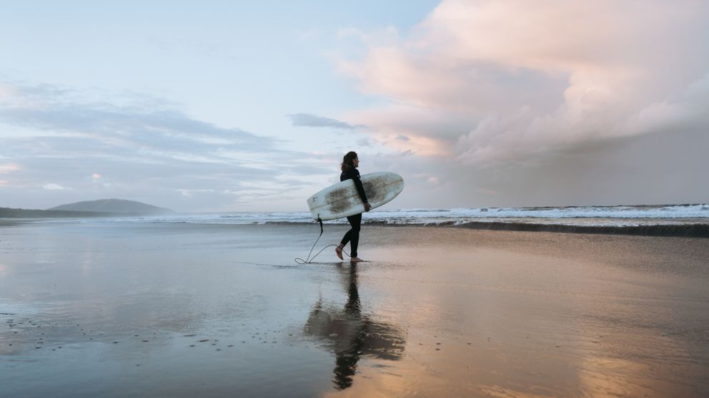 Surfer catching waves at Seven Mile Beach which stretches from Gerroa to Shoalhaven Heads
