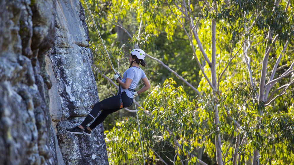 Woman enjoying an abseiling experience with Outdoor Raw in the Shoalhaven region of NSW