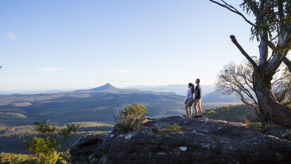 Couple enjoying panoramic views across to Pigeon House Mountain (Aboriginal: Didthul) in Morton National Park, Jervis Bay and Shoalhaven Area