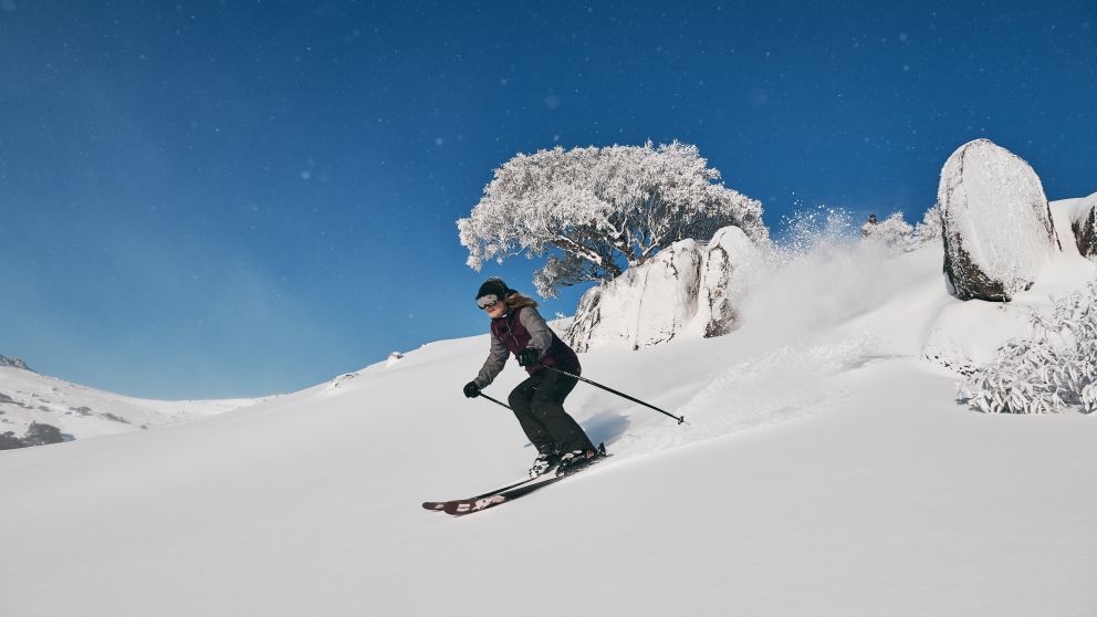 Woman enjoying a day of skiing at Charlotte Pass Ski Resort in the Snowy Mountains