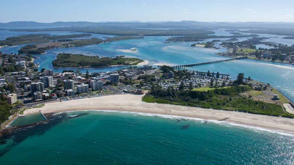 Coastal aerial overlooking Forster Beach and Forster Ocean Baths and views towards Wallis Lake and Coolongolook River, North Coast